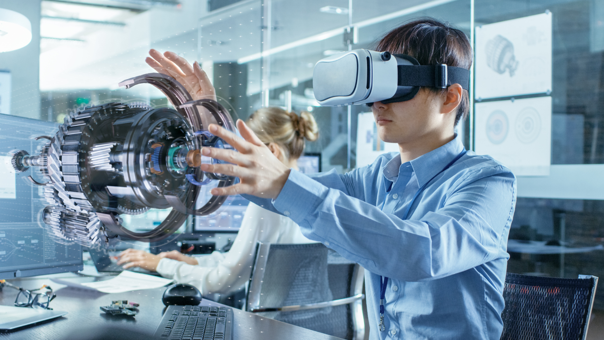 An engineer using a Virtual Reality headset to work on a digital image of a rotary engine