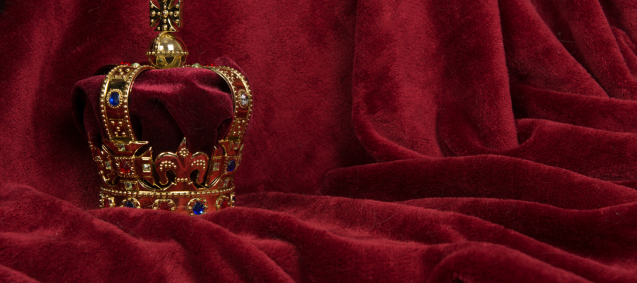 A crown on a red velvet backdrop