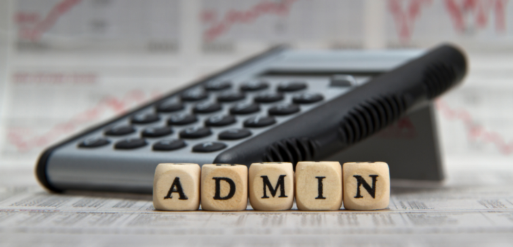 a desk calculator behind wooden blocks spelling the word Admin