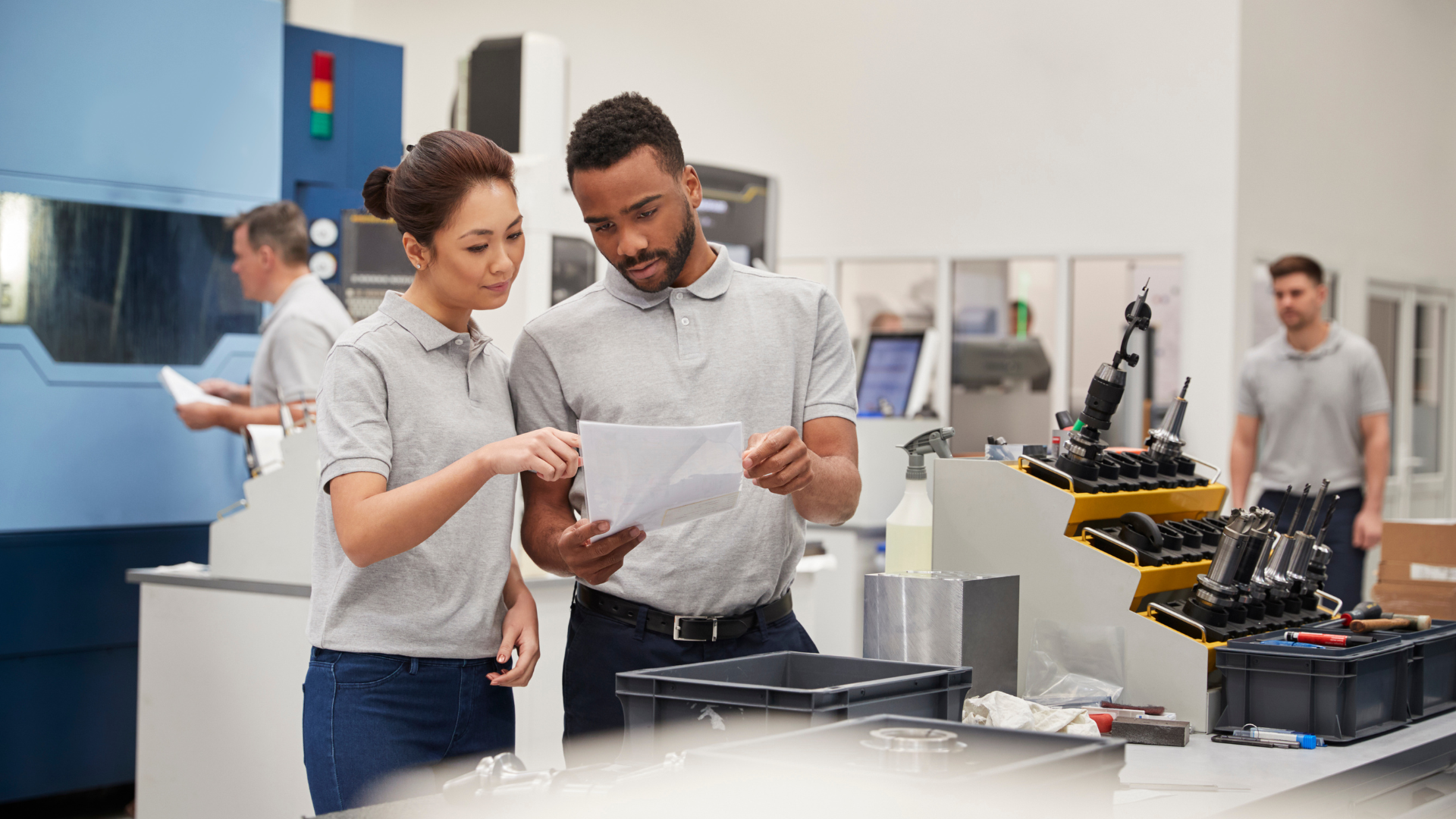 two trainee engineers looking at results