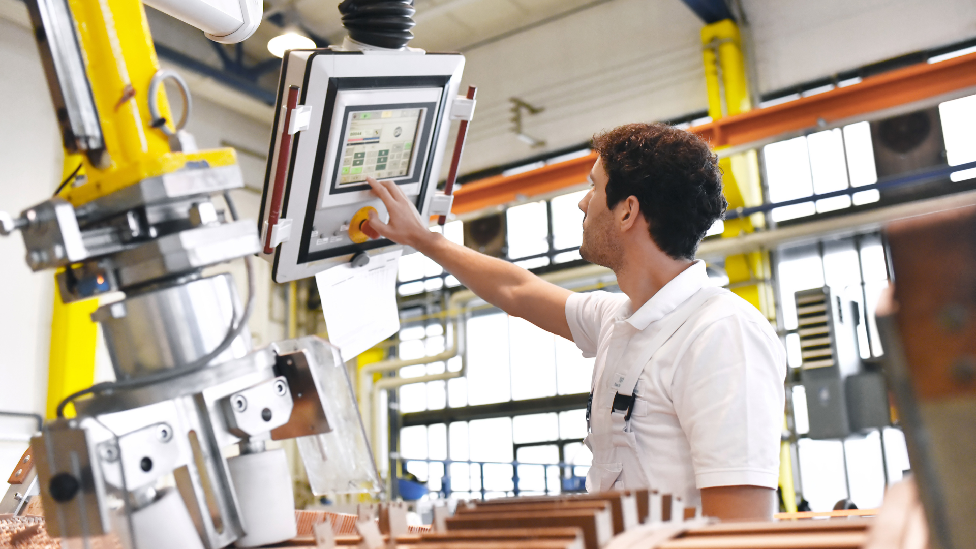 A production worker checking the status of a machine