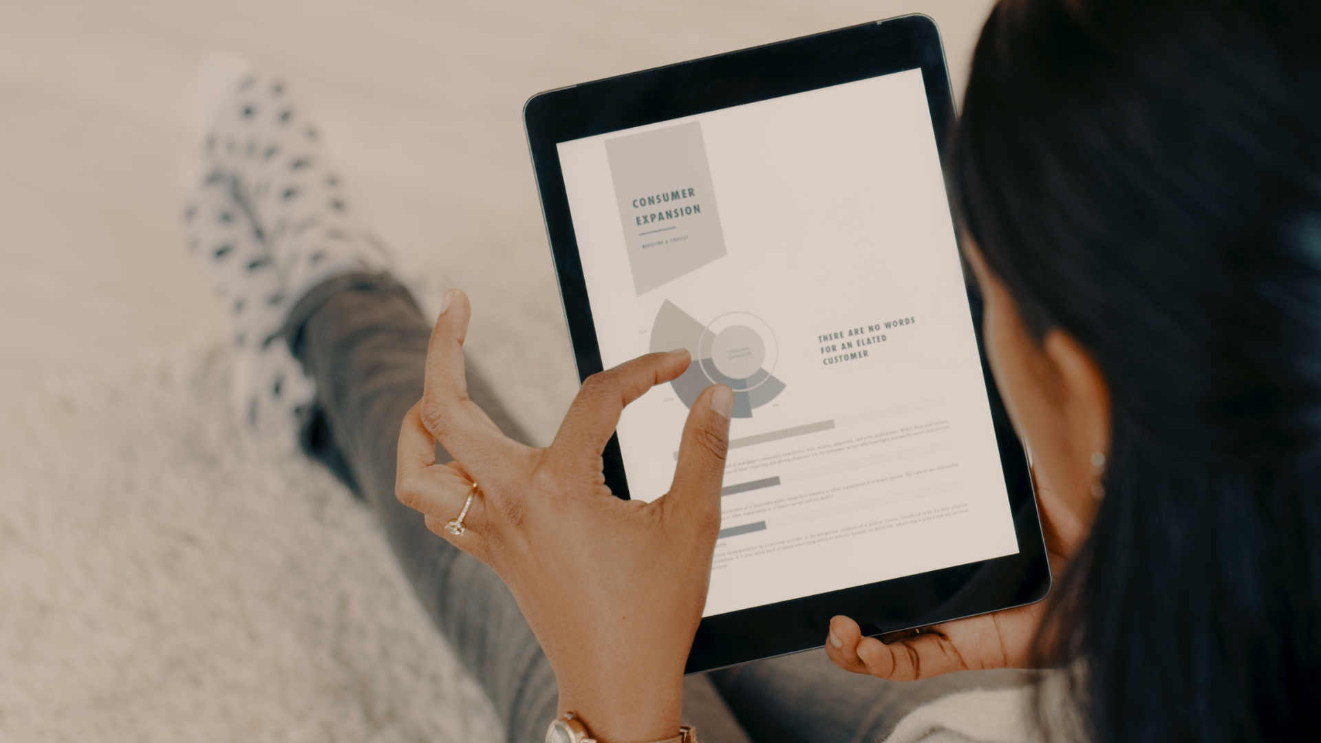 A person looking at a marketing report on a tablet