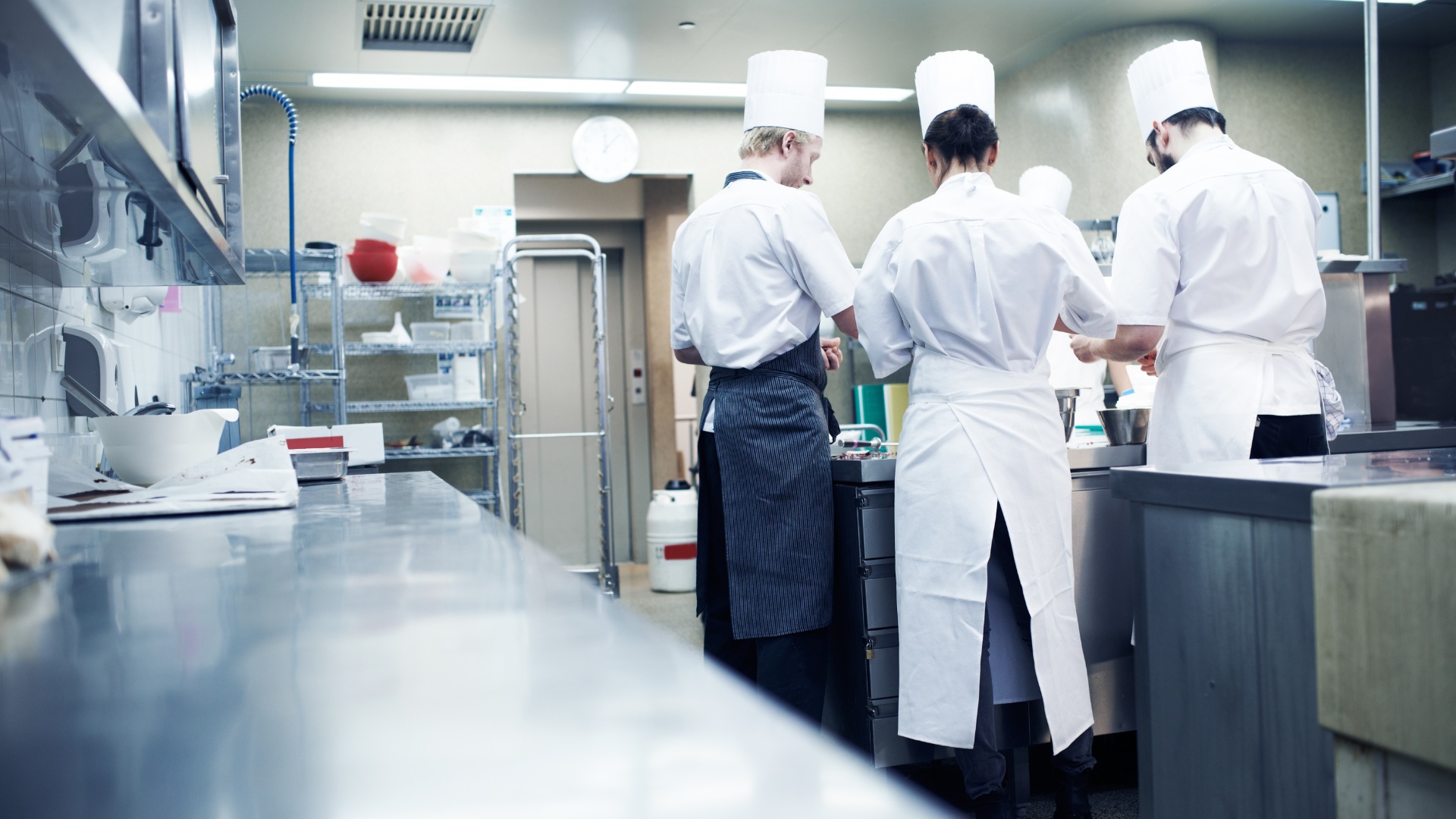 A group of chefs in a kitchen preparing a meal