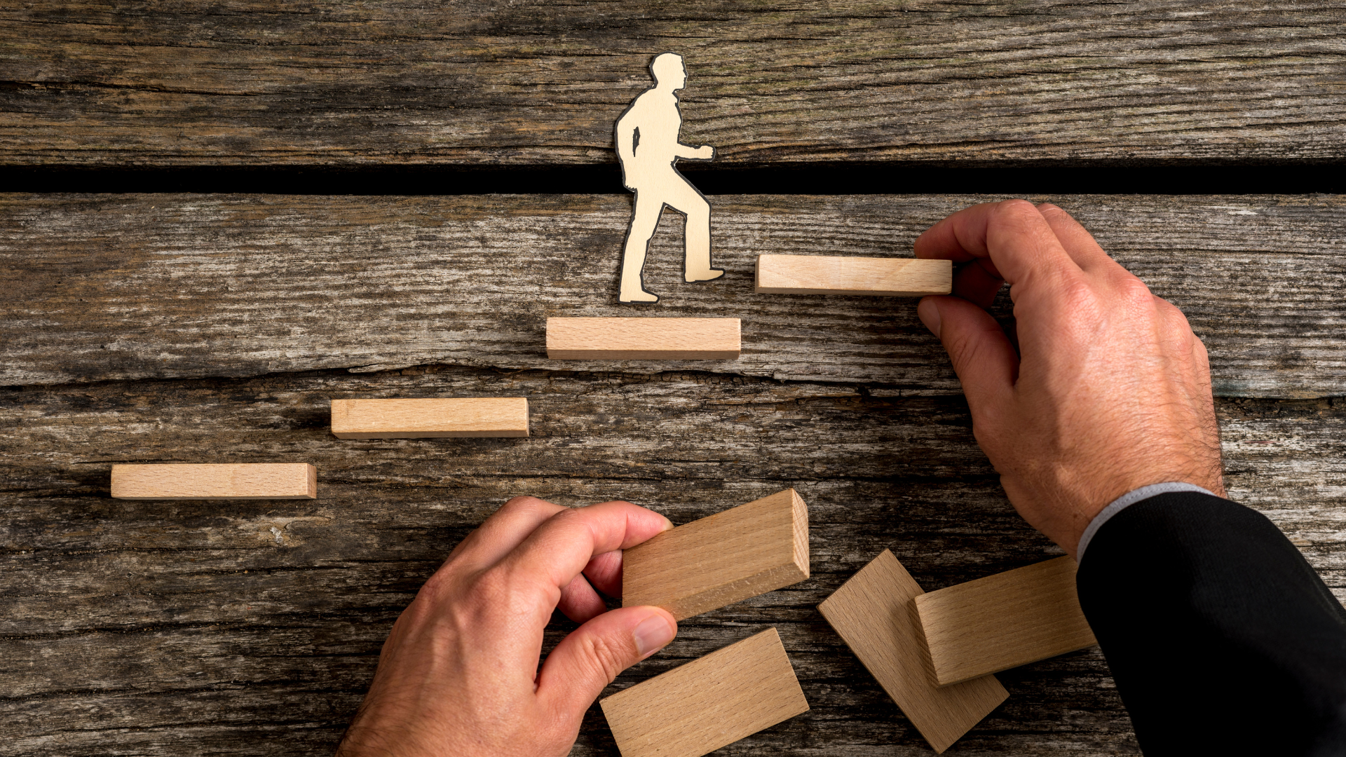 a wooden man ascending steps