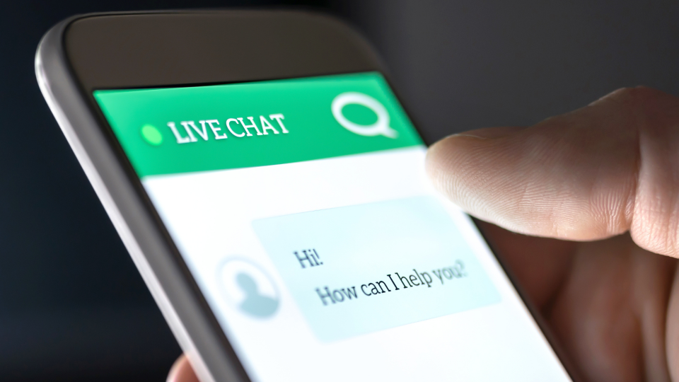 An image of a person using a live chat customer service feature on a smartphone