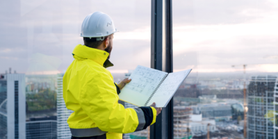 A man looking at a construction report