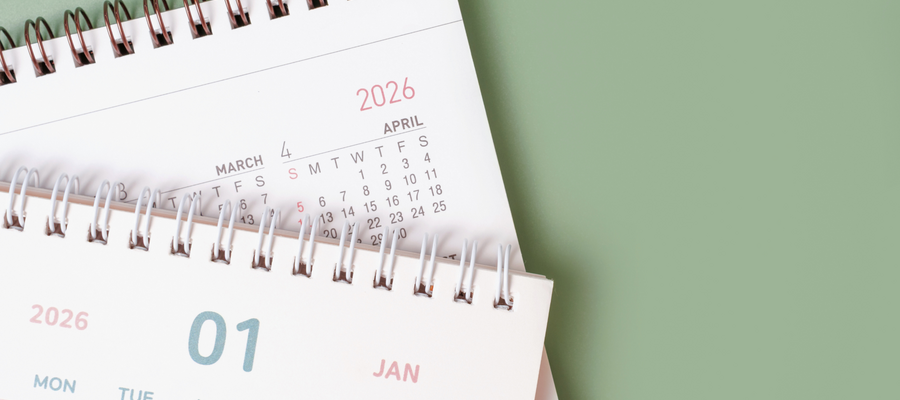 A closeup image of two calendars for 2026 on a green background. 