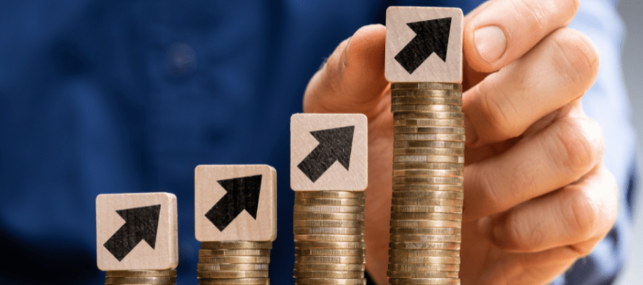 An image of stacks of coins increasing in size from left to right