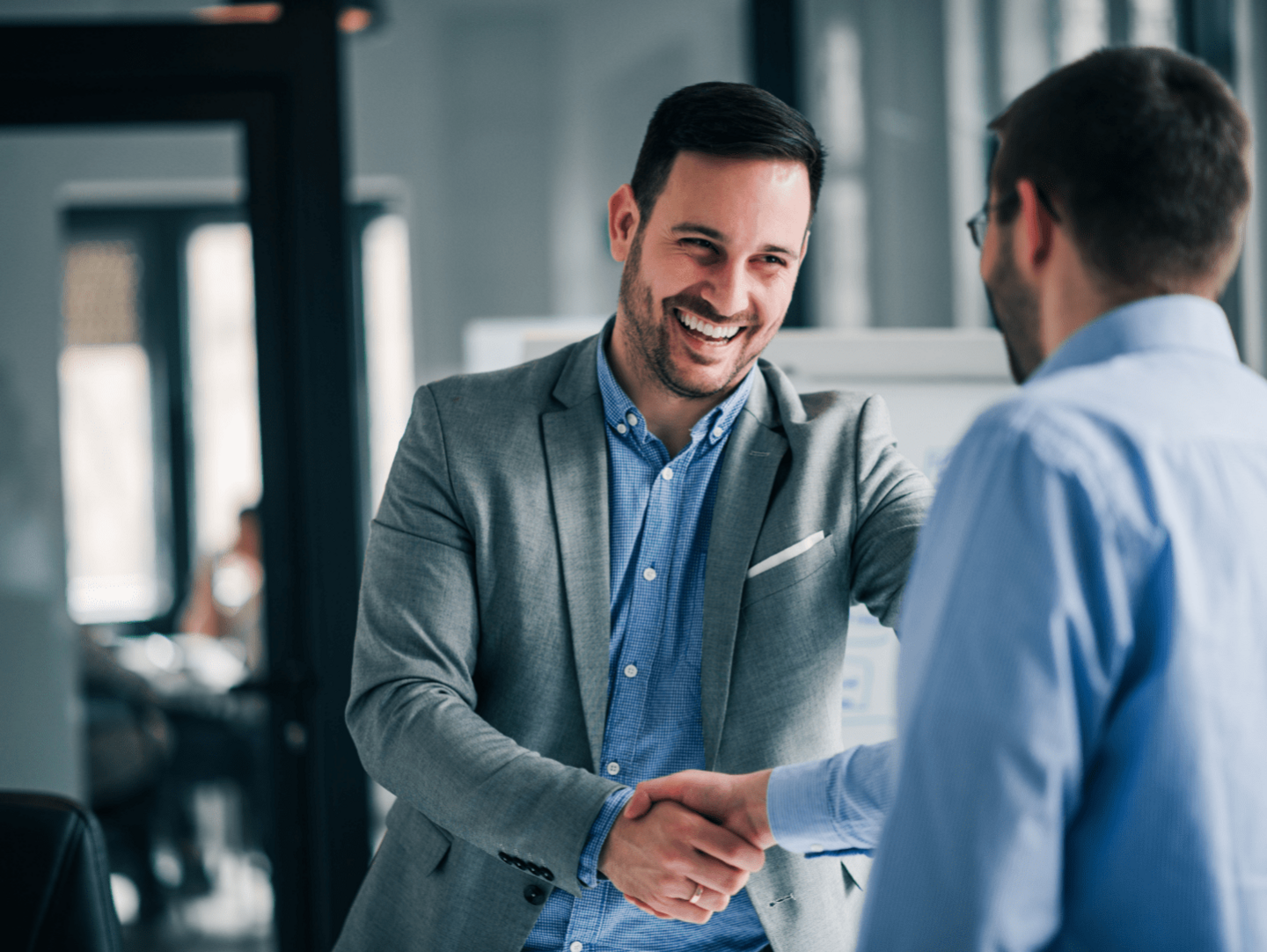 An image of two colleagues shaking hands
