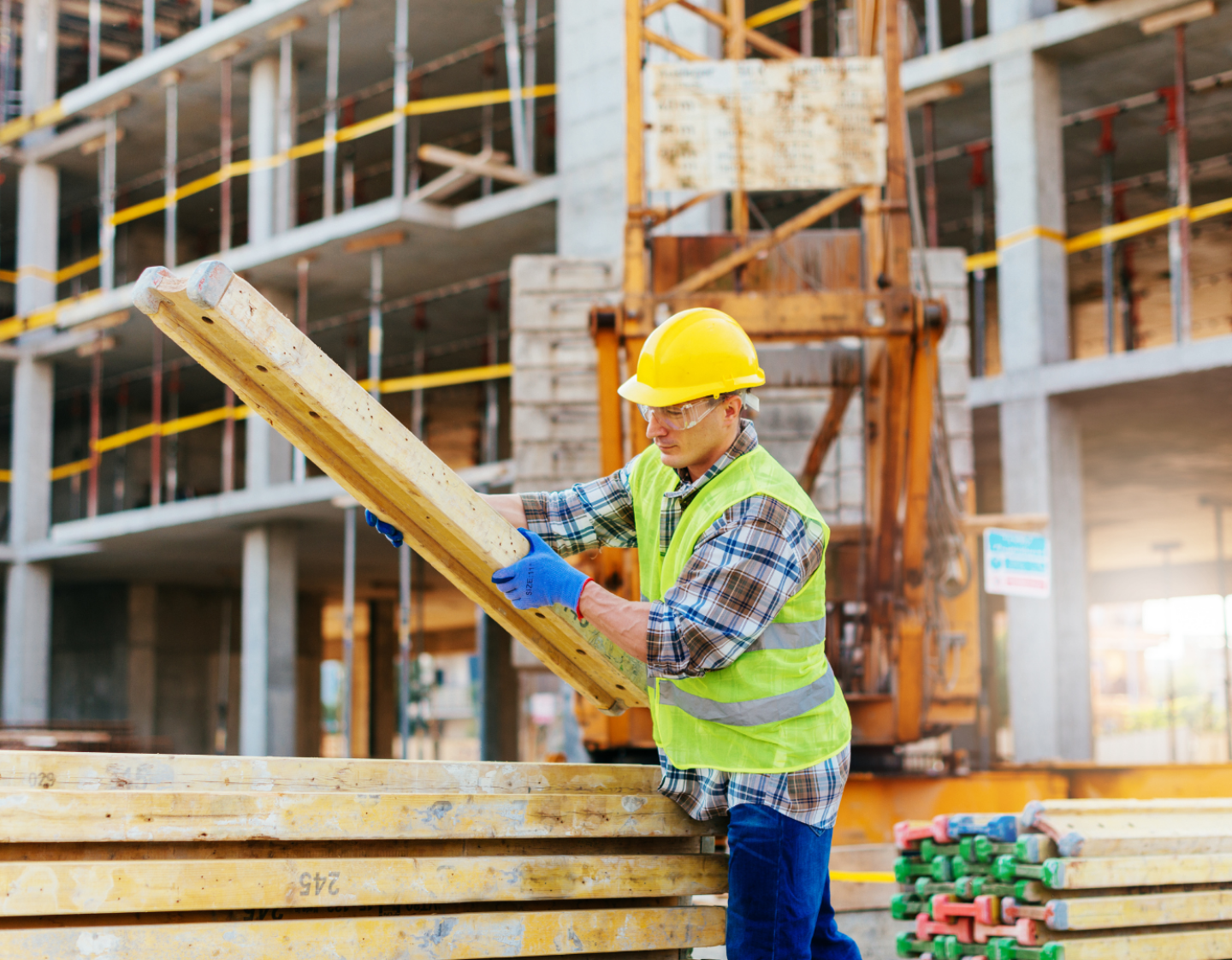 An image of a construction worker organising timber