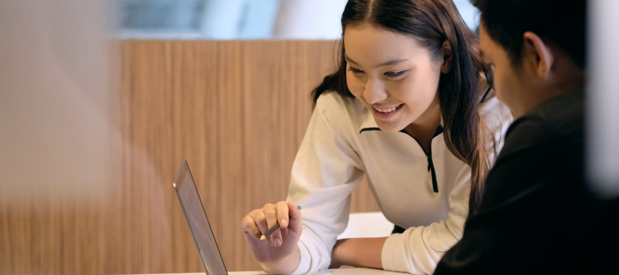 two students looking at a laptop together